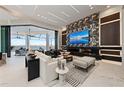 Modern living room with water views, fireplace, statement wall, and stylish furnishings at 800 Blue Shell Loop, Sarasota, FL 34240