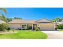 Charming single-Gathering home featuring a well-manicured lawn, attached garage, and vibrant landscaping at 914 82Nd Nw St, Bradenton, FL 34209