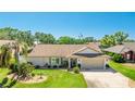 Charming single-Gathering home featuring a well-manicured lawn, attached garage, and vibrant landscaping at 914 82Nd Nw St, Bradenton, FL 34209