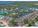 Stunning aerial view of waterfront homes with boat docks nestled among lush greenery and waterways at 1233 Dockside Pl # 207, Sarasota, FL 34242
