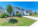 Well-manicured front yard and two-story home featuring blue and gray accents at 12738 Hysmith Loop, Parrish, FL 34219