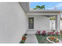 Inviting front porch with colorful flower beds and decorative front door at 1428 19Th St, Sarasota, FL 34234