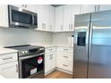 Modern kitchen featuring stainless steel appliances and white cabinets at 1428 19Th St, Sarasota, FL 34234