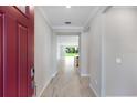 Bright entryway features tile flooring, crown molding, and a clear view of the living room beyond at 1596 Laurel Brook Ln, Port Charlotte, FL 33953