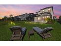Relax in the backyard with two lounge chairs overlooking the home's screened-in pool at 16226 Paynes Mill Dr, Bradenton, FL 34211