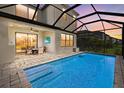 A screened-in pool with an outdoor dining area is ideal for entertaining and relaxation at 16226 Paynes Mill Dr, Bradenton, FL 34211