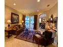 Living room with tiled floors, furniture, and a view through sliding glass doors to the pool area at 193 Montelluna Dr, North Venice, FL 34275