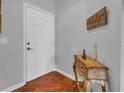 Inviting foyer featuring hardwood floors, elegant console table, and a door leading to interior spaces at 2064 Batello Dr, Venice, FL 34292