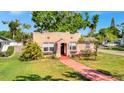 Charming single-Gathering home showcasing a quaint exterior with a red tile walkway and well-maintained lawn at 229 42Nd W St, Bradenton, FL 34209