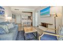 Comfortable living room featuring stylish blue accents and a flat-screen TV with beach view at 230 Sands Point Rd # 3501, Longboat Key, FL 34228