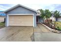Charming single-story house featuring a one-car garage, complemented by a neat front yard with lush greenery and walkway at 2309 30Th W Ave, Bradenton, FL 34205