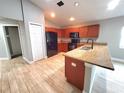 Modern kitchen with stainless steel appliances, wood cabinets, and a stylish island with a breakfast bar for casual dining at 2309 30Th W Ave, Bradenton, FL 34205