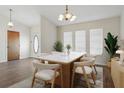 Dining room with stylish light fixture, and a table set for six, illuminated by natural light at 23116 Amethyst Ave, Port Charlotte, FL 33952