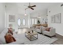 Bright living room featuring vaulted ceilings, modern decor, and a neutral color palette at 23116 Amethyst Ave, Port Charlotte, FL 33952