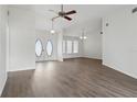 Bright living room boasts wood-look flooring, ceiling fan, and a front door with an oval glass insert at 23116 Amethyst Ave, Port Charlotte, FL 33952