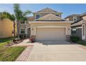 Charming two-story home with well-manicured lawn, large driveway, and a two car garage at 2332 Dovesong Trace Dr, Ruskin, FL 33570