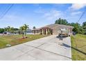 Charming single-story home with a long driveway and well-maintained lawn and boat parked in front of the house at 2396 Malibu Ln, North Port, FL 34286