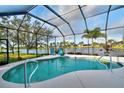 Serene pool area enclosed in a screened lanai, providing a private oasis with tranquil water views at 24342 Saragossa Ln, Punta Gorda, FL 33955