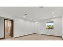 Bright, spacious bedroom with wood floors, ensuite bath, and ample natural light from the large window at 299 Australian Dr, Rotonda West, FL 33947