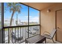 Balcony with table and chair offering a pleasant view of the surrounding area at 3006 Caring Way # 210, Port Charlotte, FL 33952