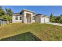 Beautiful single-story home featuring a two-car garage and well-manicured lawn at 3694 Crittendon St, North Port, FL 34286