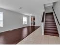 Open-concept living room with wood floors, staircase, and natural light at 4007 61St E Dr, Bradenton, FL 34203