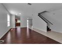 Open-concept living room with wood floors, staircase, and natural light at 4007 61St E Dr, Bradenton, FL 34203