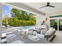 Inviting outdoor space with a fully equipped kitchen, dining table, and a view of the pool at 4013 Red Rock Ln, Sarasota, FL 34231