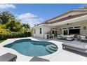 A beautifully landscaped pool with a lounge area and outdoor kitchen, ideal for entertaining guests at 4013 Red Rock Ln, Sarasota, FL 34231