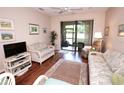 Bright living room with wood floors, comfortable seating, and sliding glass doors to the outside at 4069 Overture Cir # 341, Bradenton, FL 34209