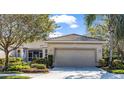 Charming home features a tile roof, manicured landscaping, and a two-car garage, enhancing its curb appeal at 4136 Cascade Falls Dr, Sarasota, FL 34243