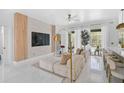 Modern living room with a decorative fireplace wall, comfortable seating, and natural light at 4146 Westbourne Cir, Sarasota, FL 34238