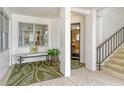 Welcoming entrance featuring a cozy bench, stylish rug, and staircase leading to the upper levels at 450 Gulf Of Mexico Dr # B207, Longboat Key, FL 34228