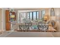 Elegant living room boasting large windows offering beautiful views and stylish furnishings at 450 Gulf Of Mexico Dr # B207, Longboat Key, FL 34228