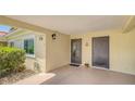 Covered front entry features neutral paint, well-lit entry, and tiled patio area at 4760 Gulf Of Mexico Dr. Villa 7, Longboat Key, FL 34228