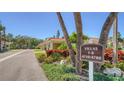Attractive villas complex with tropical landscaping, well-maintained grounds, and dedicated parking spaces at 4760 Gulf Of Mexico Dr. Villa 7, Longboat Key, FL 34228