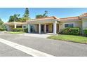 Exterior shot of villas featuring covered parking, nicely manicured lawns, and mature shrubbery at 4760 Gulf Of Mexico Dr. Villa 7, Longboat Key, FL 34228