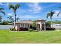 Charming single-story home featuring well-maintained landscaping, tropical palm trees, and a welcoming front entrance at 5209 26Th W Ave, Bradenton, FL 34209