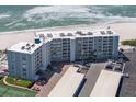 Full aerial shot of condos showing the balconies and on-site parking and beach access at 5300 Gulf Dr # 204, Holmes Beach, FL 34217