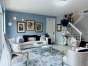 Bright living room with stylish decor, comfortable seating, and staircase access at 5360 Davini St, Sarasota, FL 34238
