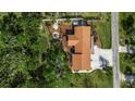 An aerial view of a beautiful home, showcasing its well-manicured yard, landscaping, and proximity to the neighborhood at 60 Liles St, Terra Ceia, FL 34250