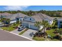 Charming single-Gathering home with a paver driveway, two-car garage, and beautifully landscaped front yard with palm trees at 6255 Cassia St, Bradenton, FL 34203