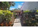 Beautiful gated entrance with lush landscaping leading to the front door at 6407 Quail Hollow Pl, Bradenton, FL 34210