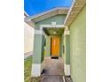 Inviting front porch with decorative accents, a yellow front door and a welcoming entrance at 7114 Hamilton Park Blvd, Tampa, FL 33615