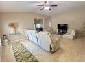 Open-concept living area with a vaulted ceiling, tile floors, and a clear view of the dining space at 7114 Hamilton Park Blvd, Tampa, FL 33615