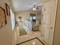Spacious living room featuring tile flooring and neutral decor, seamlessly connected to the dining area at 7114 Hamilton Park Blvd, Tampa, FL 33615