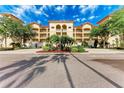 Beautiful condo complex with lush landscaping, inviting entry, and elegant architectural details at 7710 Lake Vista Ct # 407, Lakewood Ranch, FL 34202