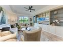 Bright living room with a built-in entertainment center, comfortable seating, and scenic views at 7710 Lake Vista Ct # 407, Lakewood Ranch, FL 34202
