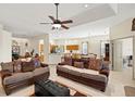 Spacious living room with tile floors, a ceiling fan, and open layout to the kitchen and dining area at 8271 47Th Street E Cir, Palmetto, FL 34221