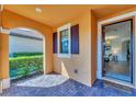 Welcoming front porch with brick pavers, view to the inside of the home at 10072 Cozy Grove Dr, Venice, FL 34293